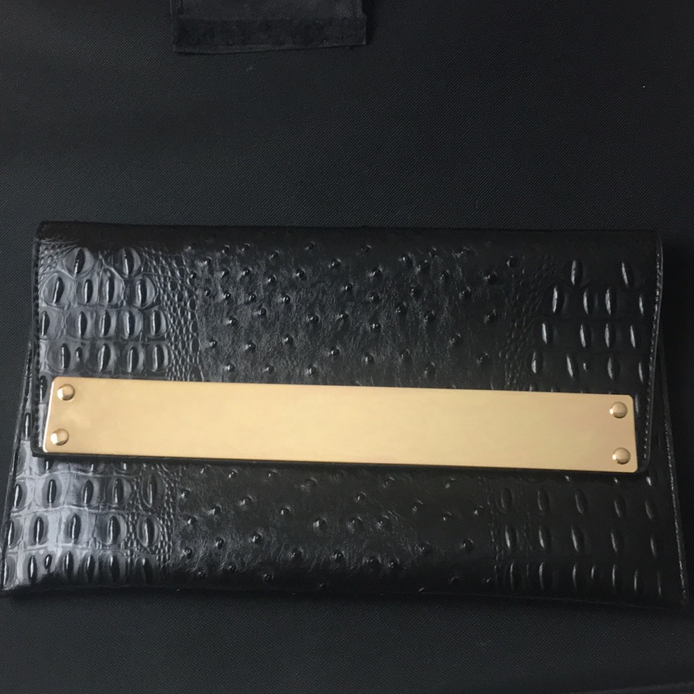 Black and gold clutch purse with gold chain